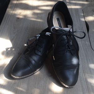 Black tie loafer with gold embellishments